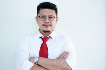 Portrait of a handsome Asian man wearing glasses. Wear a white shirt and red tie.