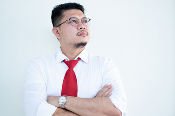 Portrait of a handsome Asian man wearing glasses. Wear a white shirt and red tie.