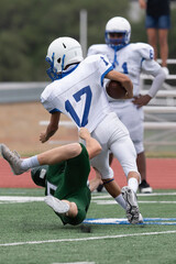 Boy athlete playing in a competitive football game