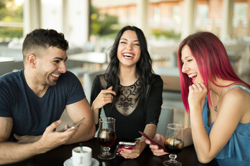 group of friends laugh and enjoy a coffee in restaurant bar