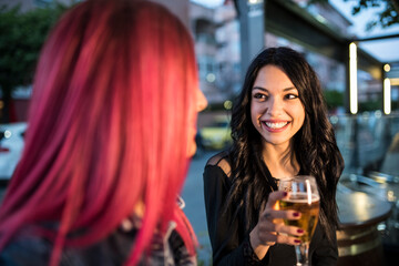 pretty women have a happy conversation in a bar