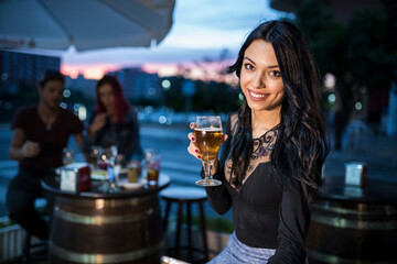  pretty woman drinking beer in bar terrace