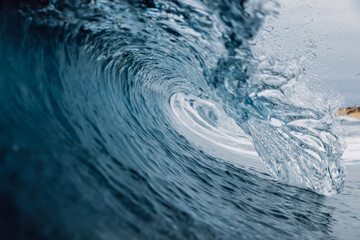 Perfect sea waves with blue water cloudy sky.