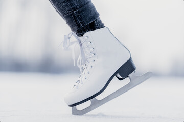 handstand on the tips of ice skates on a frozen winter lake