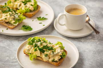 Egg salad sandwiches, on light background.