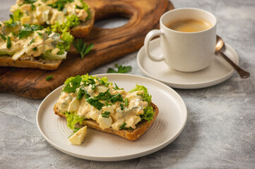 Egg salad sandwiches, on light background.