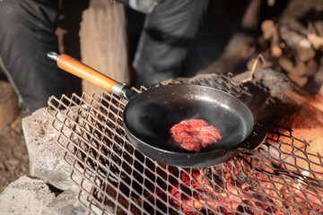 Burger beef cooking on campfire