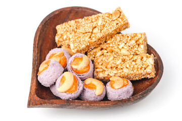  Traditional Thai dessert called Krayasart made from rice, nuts, sesame and sugar with taro cookies in a heart wooden bowl.