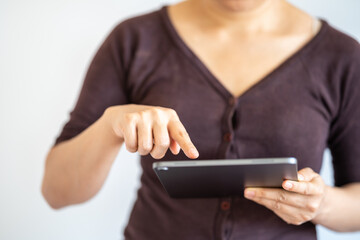 Business and Technology Concept. Closeup of woman hands using and holding tablet on white background.