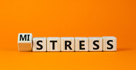 Mistress or stress symbol. Turned a cube and changed the word 'mistress' to 'stress'. Beautiful orange background. Mistress or stress and business concept. Copy space.