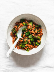 Bolognese sauce with kale on a light background, top view