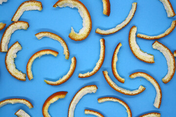 Dried orange peel on a blue background.