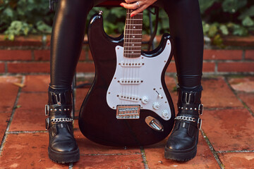 Rocker woman posing with a guitar.