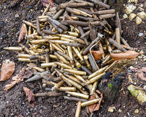 a collection of British Army soldier used bullet casings at a sniper point after a military exercise