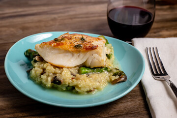 Sea bass over risotto meal close up
