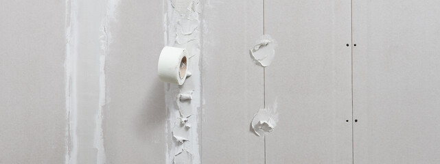 drywall construction repair concept, procedure for leveling plasterboard walls with stucco and mesh...