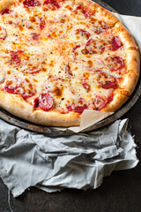 pepperoni pizza meat salami sausage double cheese fast food Takeaway on the table meal snack top view copy space for text food background rustic