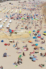 Algarve beach full of people sunbathing, Praia da Rocha, Portimão, Portugal