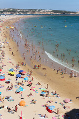 View of the Praia da Rocha beach full of people sunbathing, Portimão, Algarve, Portugal