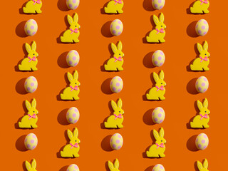 Rabbit pattern. Abstract background. Cute colorful design for children. Bright yellow spotted Easter egg cookie bunny minimal decoration isolated on fun vivid orange wallpaper for boy or girl.