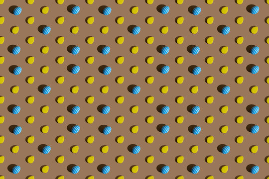 Easter background. Colorful seamless pattern. Holiday decoration. Blue painted stripped eggs yellow cookie pattern symmetrical mosaic composition isolated on beige abstract backdrop.