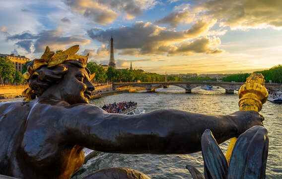 The Nymph reliefs on the bridge of Alexander III with the Eiffel Tower on background at sunset in Paris, France. Architecture and landmarks of Paris. Postcard of Paris