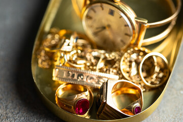 Old and broken jewelry, vintage watches on dark background. Sell  gold for cash concept.