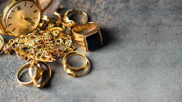 Old and broken jewelry, vintage watches on dark background. Sell  gold  for cash concept.