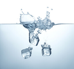 ice cubes dropping in water with splash isolated on white background