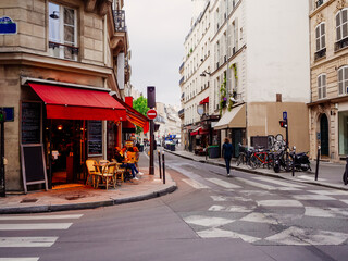 Fototapeta na wymiar Cozy street with tables of cafe in Paris, France