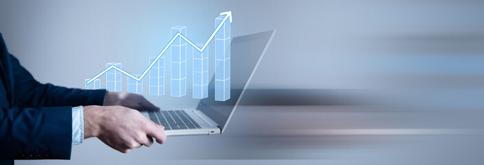 man holding computer with graph