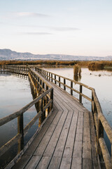 Wooden walkway over the water of the lake in the natural park 