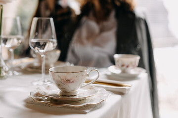Vintage porcelain cup of coffee with a small plate at breakfast in a restaurant.