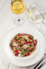 Pasta with veal on a white wooden table
