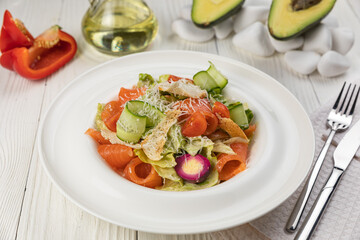 Salmon salad on a white wooden table
