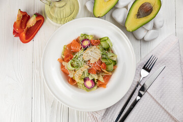 Salmon salad on a white wooden table
