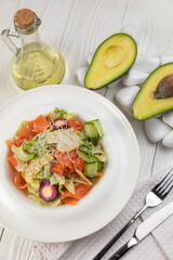 Salmon salad on a white wooden table
