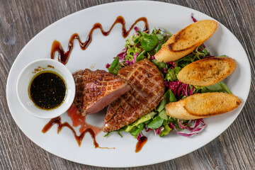 grilled duck breast with honey sauce and salad