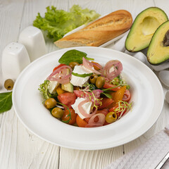 Cheese salad on a white wooden table
