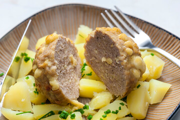 meat ball baked with beans and cheese served with potatoes