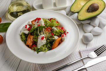 Seafood salad on a white wooden table
