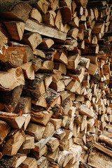 Pile of stacked triangle firewood prepared for fireplace and boiler. High quality photo