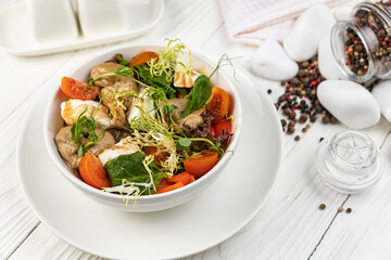 Cheese salad on a white wooden table
