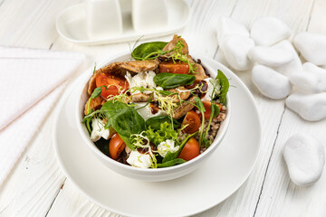 Cheese salad on a white wooden table
