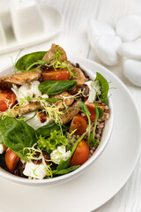 Cheese salad on a white wooden table
