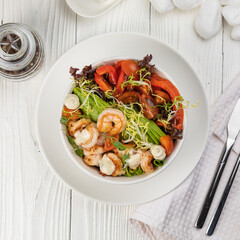 Seafood salad on a white wooden table
