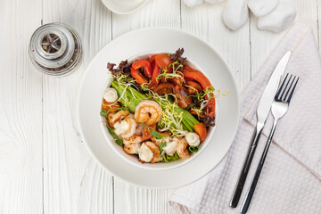 Seafood salad on a white wooden table
