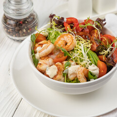 Seafood salad on a white wooden table
