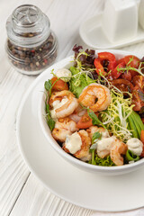 Seafood salad on a white wooden table

