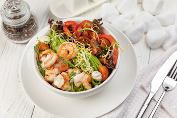 Seafood salad on a white wooden table
